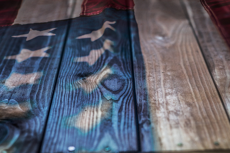 Vintage American Flag painted on aged, weathered rustic wooden Background.の写真素材