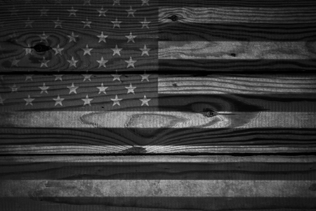 Vintage American Flag painted on aged, weathered rustic wooden Background.の写真素材