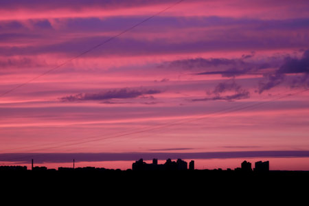 Urban silhouette city skyline, pink sunset / sunrise.の写真素材