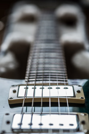 Electric guitar pickups and neck close up view unocused