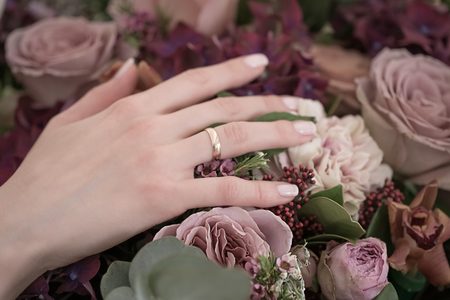 Bride hand holding wedding flowers bouquet.の写真素材