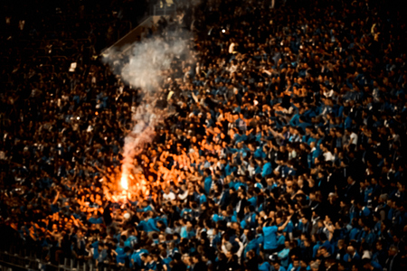 Football fans cheer their soccer team score goal with the fire at the stadium.の写真素材