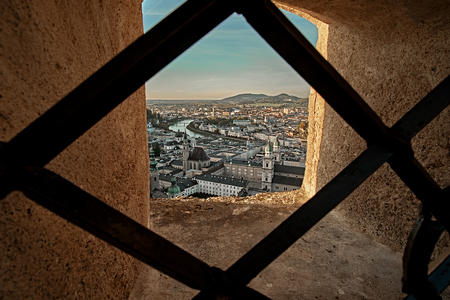 Beautiful sunset aerial view on Salzburg, Austria, Europe. City in Alps of Mozart birth. View of Salzburg skyline from Festung Hohensalzburg castle fortress window.の写真素材