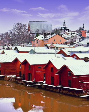 Old historic Porvoo, Finland with wooden houses and medieval stone and brick Porvoo Cathedral under white snow in winter.の写真素材