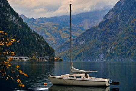 Beautiful scenic view over calm and peaceful Austrian alps lake. Lonely boat or yacht in the evening...