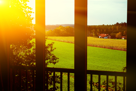 Bright rural landscape with country houses in the morning sun.の写真素材