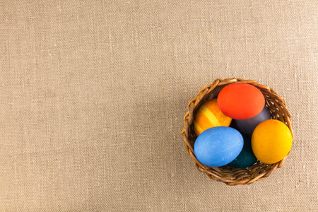 Colored eggs in the basket, prepared for the Easter holiday.