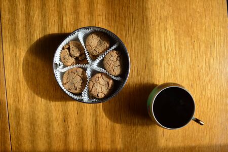 Tin can with cookies on a wooden table., top viewの写真素材