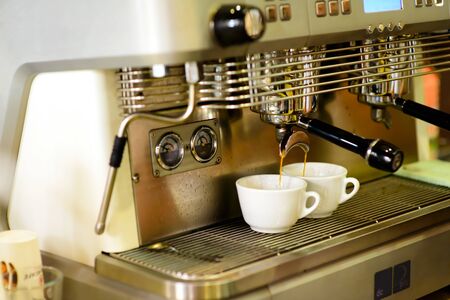prepares espresso in his coffee shop close-upの写真素材
