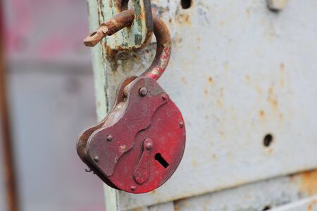 Close up, padlock hanging at vintage doorの写真素材
