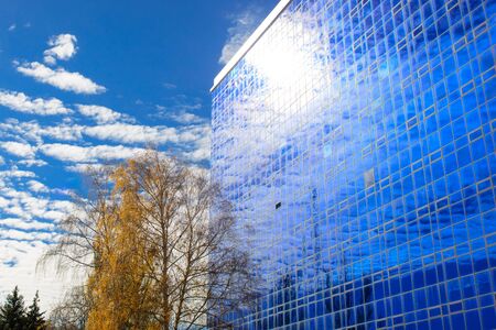 Clouds reflected in windows of modern building.の写真素材
