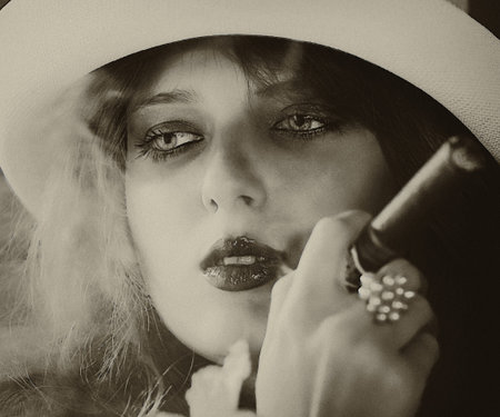Elegant smoking woman. Portrait of a red-haired girl with a cigar.