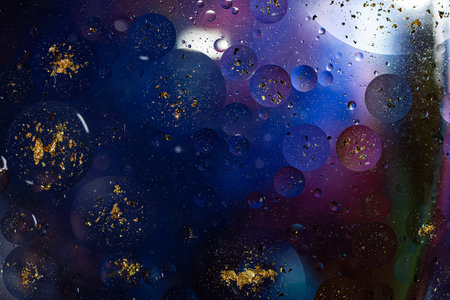 Photo of oil on a water surface with bubbles. Abstract colorful background. Macro close-up, not...