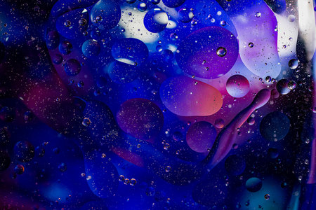 Photo of oil on a water surface with bubbles. Abstract colorful background. Macro close-up, not...