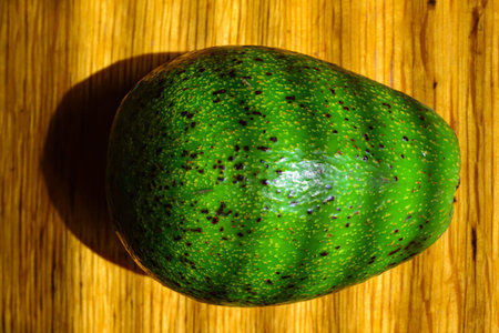 Avocado fruit on a wooden table in the morning light.