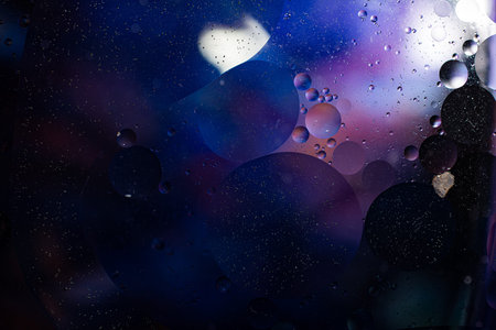 Photo of oil on a water surface with bubbles. Abstract colorful background. Macro close-up, not...