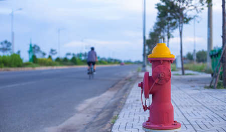 A new fire hydrant was installed on the sidewalk, next to the main road. In a residential area about to be built.の写真素材