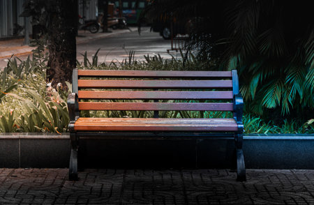Wooden chairs on the sidewalk in dark tones, with two streams of hot and cold light on either side. Hot and cold contrasting background concept. nobody.の写真素材