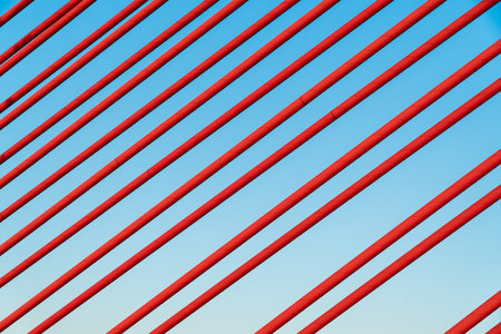 Red cable of a cable car bridge. Red wire background. Symmetry concept, construction.の写真素材