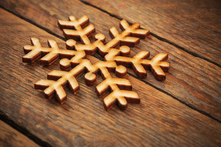 wooden snow flake on plankの写真素材