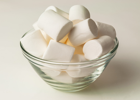marshmallow in a glass bowl on whiteの写真素材