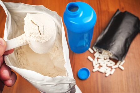 protein powder, bcaa pills and blue shakerの写真素材
