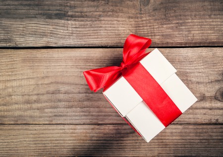 white gift box with red ribbonの写真素材