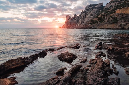 beautiful sunset and rocky sea beachの写真素材