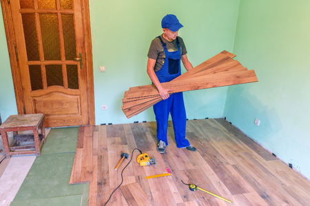 master chooses laminate plank in the roomの写真素材