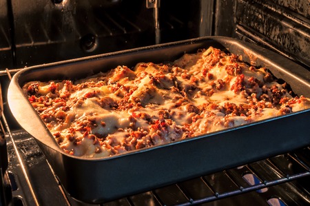 delicious lasagna in the ovenの写真素材