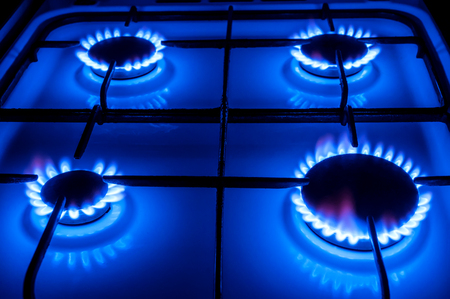 four gas burners with blue flameの写真素材