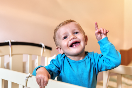 happy and smiling little boy (child) pointing fingerの写真素材