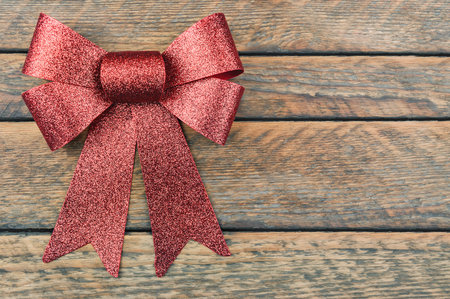 red shining bow on wooden background
