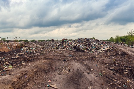 illegal garbage dump and cloudy skyの写真素材