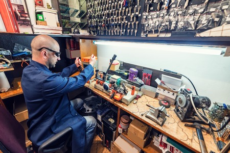 locksmith in workshop makes new keyの写真素材