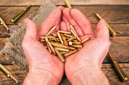 real bullets (ammunition) with shells in the hands