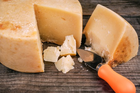 pieces of delicious pecorino (parmesan) cheese with special knifeの写真素材