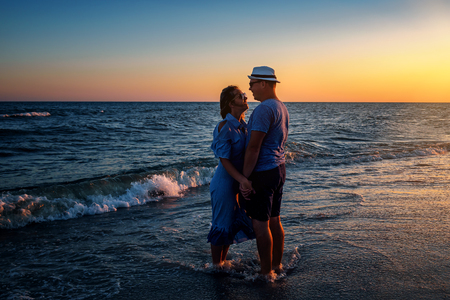 happy couple on the sunset beachの写真素材