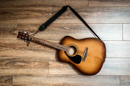 professional acoustic guitar hanging on the wooden wallの写真素材