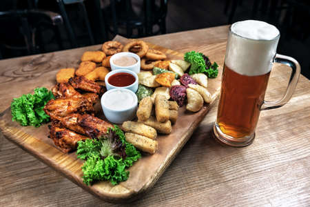 different snack and glass of beerの写真素材