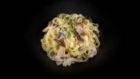 Delicious pasta on the black plateの写真素材