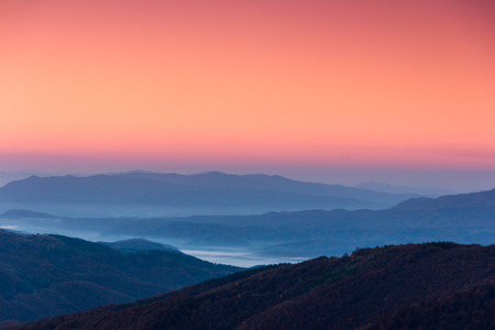 Beautiful landscape at dawn. Layers of mountain in pink light.の写真素材