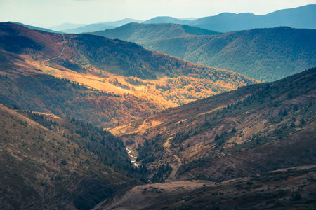 Scenic view of mountains, autumn landscape with colorful hills. Filtered image: cross processed...