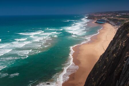 Amazing landscape of the beach of Praia Grande. View of Atlantic coastline - a long sandy beach and big waves. Sintra. Portuguese riviera. Portugal.の写真素材