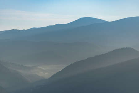 Amazing landscape in summer. Light and afternoon shadow over scenic mountain hills, clear blue sky. mountain valley.の写真素材