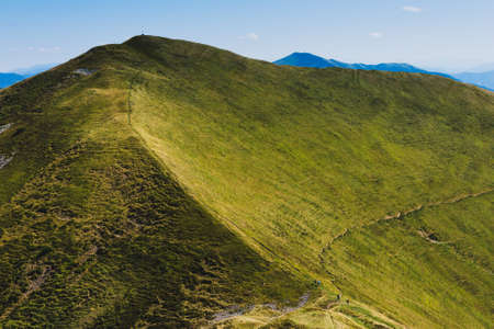 Amazing landscape in summer. Light and afternoon shadow over scenic mountain hills, clear blue sky. mountain valley.の写真素材
