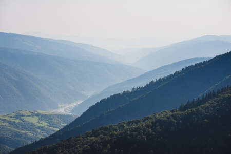 Amazing landscape in summer. Light and afternoon shadow over scenic mountain hills, clear blue sky. mountain valley.の写真素材
