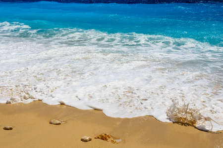 Summer seascape beautiful waves, blue sea water in sunny day. View of beautiful bright sea with waves splashing and beach sand.の写真素材