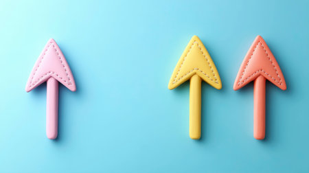 The image displays three stylized arrows pointing directly upwards, each rendered in a soft pastel shade: pink on the left, yellow in the center, and peach on the right. The arrows feature subtle stitched detailing along their edges, giving them a crafted or tactile appearance. They are evenly spaced against a solid, vibrant blue background.の素材