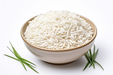 Rice grains in a wooden bowl on a white background.の素材